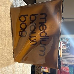 Used - Medium brown bag purse - see photos - a few white marks on the bag.